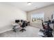 Home office with plush gray carpeting and ample natural light at 117 Villanueva Rd, Woodstock, GA 30188
