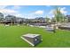Community space features a lawn game area with well-maintained turf and nearby seating at 117 Villanueva Rd, Woodstock, GA 30188