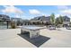 Recreation area with ping pong table, tables and chairs surrounded by community pool and houses at 117 Villanueva Rd, Woodstock, GA 30188