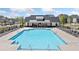 Beautiful community pool with lounge chairs, tables and clubhouse overlooking the refreshing water at 117 Villanueva Rd, Woodstock, GA 30188
