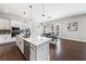Modern kitchen features white cabinets, stainless appliances, and a bright, airy breakfast area at 117 Villanueva Rd, Woodstock, GA 30188