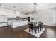 Open concept kitchen with white cabinets, large island, and stainless steel appliances at 117 Villanueva Rd, Woodstock, GA 30188