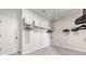 Walk-in closet with carpet flooring, white door and built-in shelving with black and beige storage boxes at 117 Villanueva Rd, Woodstock, GA 30188