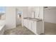 Bathroom featuring dual sink vanity with large mirror at 12098 Conrad Cir, Hampton, GA 30228