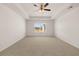 Large bedroom featuring carpet, ceiling fan, and a window with natural light at 12098 Conrad Cir, Hampton, GA 30228