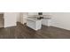 Open kitchen and living area with white cabinets and granite countertops at 12098 Conrad Cir, Hampton, GA 30228