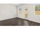 Well-lit room with vinyl floors, large windows, and a door leading to the backyard at 12098 Conrad Cir, Hampton, GA 30228