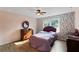Comfortable bedroom with floral wallpaper, wood floors, and ceiling fan at 12421 Highway 36, Covington, GA 30014