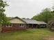 Exterior view of this traditional ranch home on a vast grassy lot at 12421 Highway 36, Covington, GA 30014
