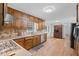 Traditional kitchen with wood cabinets, stainless steel appliances, and a window above the sink at 12421 Highway 36, Covington, GA 30014