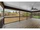 Spacious porch featuring a ceiling fan and a picturesque view of the backyard pond at 12421 Highway 36, Covington, GA 30014