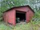 Exterior view of the shed with storage in the backyard of the property at 12421 Highway 36, Covington, GA 30014