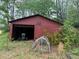 Exterior view of the shed with storage in the backyard of the property at 12421 Highway 36, Covington, GA 30014