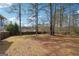 A large, fenced backyard with mature trees and a spacious grassy area at 3640 Barbara Dr, Douglasville, GA 30135