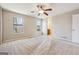 Spacious bedroom featuring plush carpeting, ceiling fan, and two bright windows at 3640 Barbara Dr, Douglasville, GA 30135