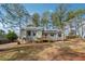 Charming gray home featuring a well-maintained lawn and a welcoming red front door at 3640 Barbara Dr, Douglasville, GA 30135