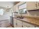 Close up of the kitchen sink, countertops and custom lighting at 3640 Barbara Dr, Douglasville, GA 30135