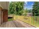 View of a wooden back deck with a brick exterior and a backyard shed at 4135 Shoshone Valley Rd, Marietta, GA 30068