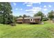 Lush backyard with expansive lawn, mature trees, and multiple decks at 4135 Shoshone Valley Rd, Marietta, GA 30068