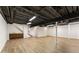 Spacious basement with wood flooring, open ceiling, exposed beams, and support beams at 4135 Shoshone Valley Rd, Marietta, GA 30068