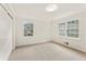 Bright carpeted bedroom with two large windows, closet and neutral color palette for personalization at 4135 Shoshone Valley Rd, Marietta, GA 30068