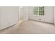 Comfortable carpeted bedroom with a large window that provides ample natural light at 4135 Shoshone Valley Rd, Marietta, GA 30068