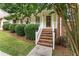 Inviting brick front porch with classic white railings and manicured shrubbery at 4135 Shoshone Valley Rd, Marietta, GA 30068