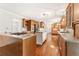 Open kitchen layout with island cooktop, wood cabinetry, and bright lighting at 4135 Shoshone Valley Rd, Marietta, GA 30068