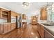 Open kitchen with wood cabinets, stainless steel appliances, and hardwood floors at 4135 Shoshone Valley Rd, Marietta, GA 30068