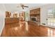 Open-concept living room flowing into the kitchen with hardwood floors and a brick fireplace at 4135 Shoshone Valley Rd, Marietta, GA 30068