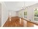 Large living room with hardwood floors, bright windows, and classic chandelier lighting at 4135 Shoshone Valley Rd, Marietta, GA 30068