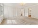 Sunlit main bedroom with neutral carpet, large closet space, and access to the ensuite bathroom at 4135 Shoshone Valley Rd, Marietta, GA 30068