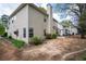 Backyard with partial patio, showing the exterior of the two-story home with neutral siding at 1074 Frog Leap Nw Trl, Kennesaw, GA 30152