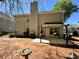 Backyard view with patio, partial pergola, and the exterior of the two-story home at 1074 Frog Leap Nw Trl, Kennesaw, GA 30152