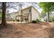 Backyard featuring a partial patio area and exterior of a two-story home with neutral siding at 1074 Frog Leap Nw Trl, Kennesaw, GA 30152