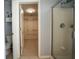 Bathroom with walk-in shower and open doorway to a walk-in closet with metal shelving at 1074 Frog Leap Nw Trl, Kennesaw, GA 30152
