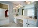 Bathroom featuring double sinks, ample countertop space, and a large mirror for a bright feel at 1074 Frog Leap Nw Trl, Kennesaw, GA 30152