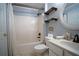 Bathroom with a shower-tub combo, modern fixtures, and decorative shelves for storage at 1074 Frog Leap Nw Trl, Kennesaw, GA 30152