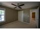 Comfortable carpeted bedroom with overhead lighting and double door closet for storage space at 1074 Frog Leap Nw Trl, Kennesaw, GA 30152