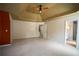 Expansive carpeted bedroom with a tray ceiling, multiple doorways, and neutral walls at 1074 Frog Leap Nw Trl, Kennesaw, GA 30152