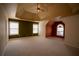 Large carpeted bedroom with a tray ceiling and multiple windows providing natural light at 1074 Frog Leap Nw Trl, Kennesaw, GA 30152