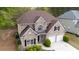 Aerial view of a charming brick home with a two-car garage, professional landscaping, and a private backyard at 1074 Frog Leap Nw Trl, Kennesaw, GA 30152