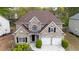 A stately two-story brick home featuring a two-car garage and professional landscaping at 1074 Frog Leap Nw Trl, Kennesaw, GA 30152