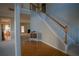 Bright foyer features hardwood floors, staircase with wood railings, and view into living spaces at 1074 Frog Leap Nw Trl, Kennesaw, GA 30152