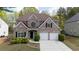 Beautiful two-story brick home with a two-car garage and manicured landscaping at 1074 Frog Leap Nw Trl, Kennesaw, GA 30152