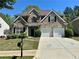 Charming two-story brick home with a well-manicured front lawn and a two-car garage, perfect for a Gathering at 1074 Frog Leap Nw Trl, Kennesaw, GA 30152
