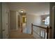 Upstairs hallway with carpet flooring and modern lighting leads to various bedrooms and bathrooms at 1074 Frog Leap Nw Trl, Kennesaw, GA 30152