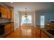 Charming eat-in kitchen boasts hardwood floors and a view of the bright, sunny living room at 1074 Frog Leap Nw Trl, Kennesaw, GA 30152