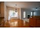 Eat-in kitchen with hardwood floors and modern light fixtures, leading to the living room at 1074 Frog Leap Nw Trl, Kennesaw, GA 30152