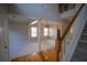Spacious living room with large windows, columns, and stairs to the upper level at 1074 Frog Leap Nw Trl, Kennesaw, GA 30152